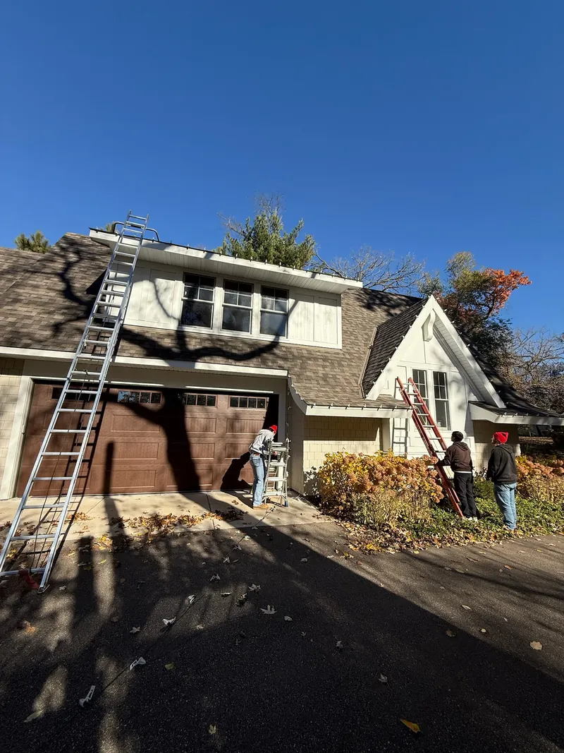 Ladders up against a house while the crew works on the roofline