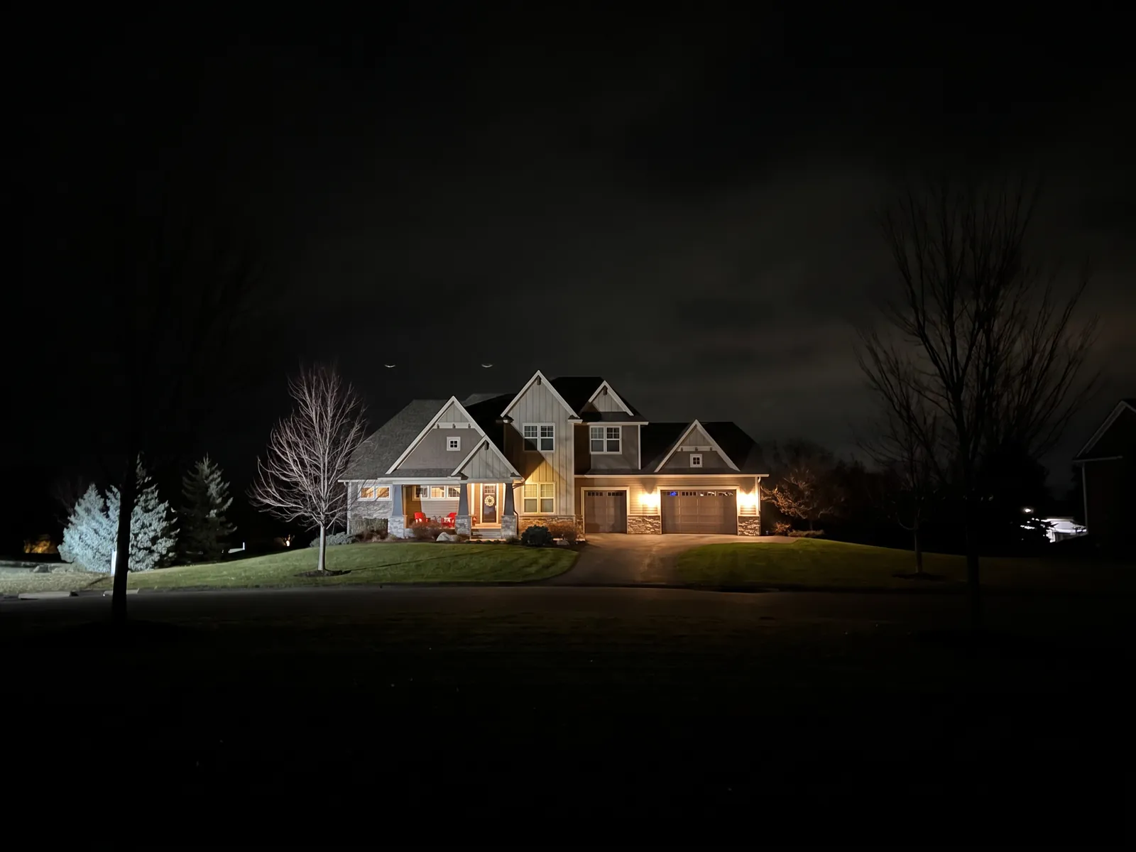 The same home and trees with no Christmas lights